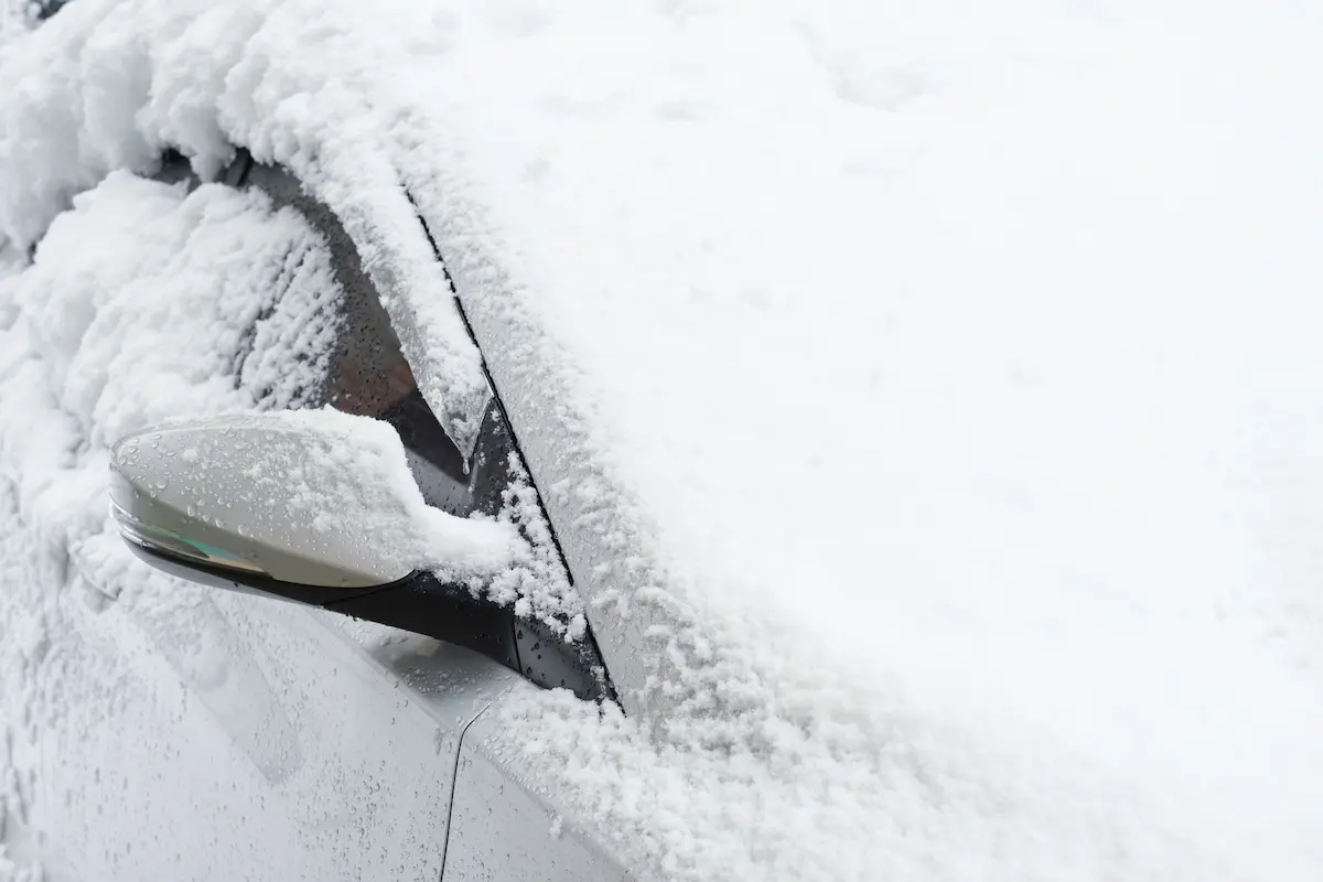 Closeup view of white snow on a car windshield