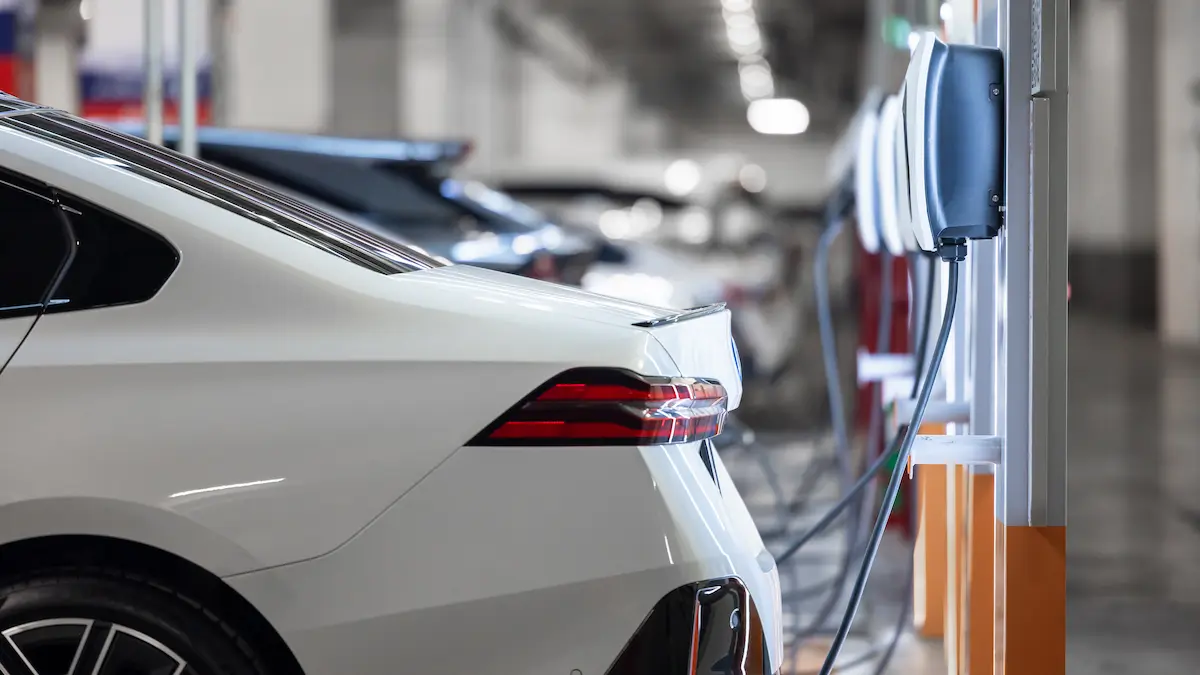 Electric car charging at a charging station.