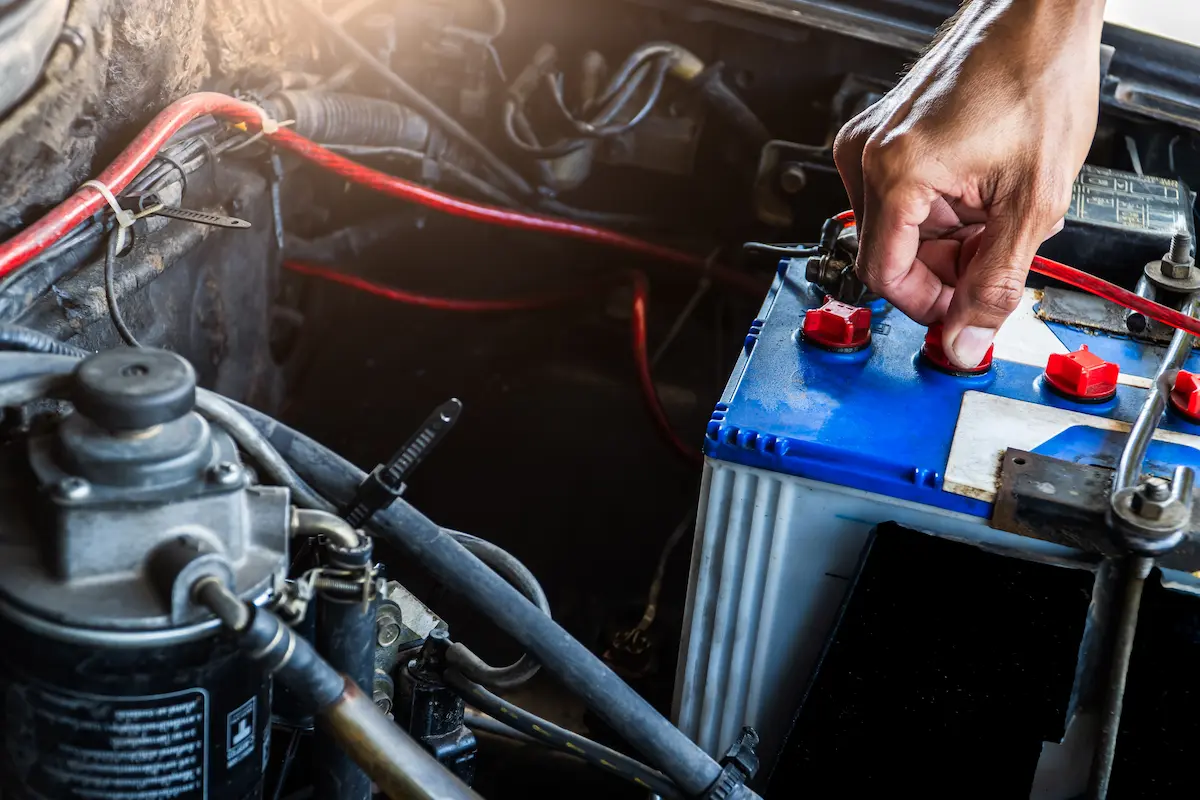 Service technician checking a car battery
