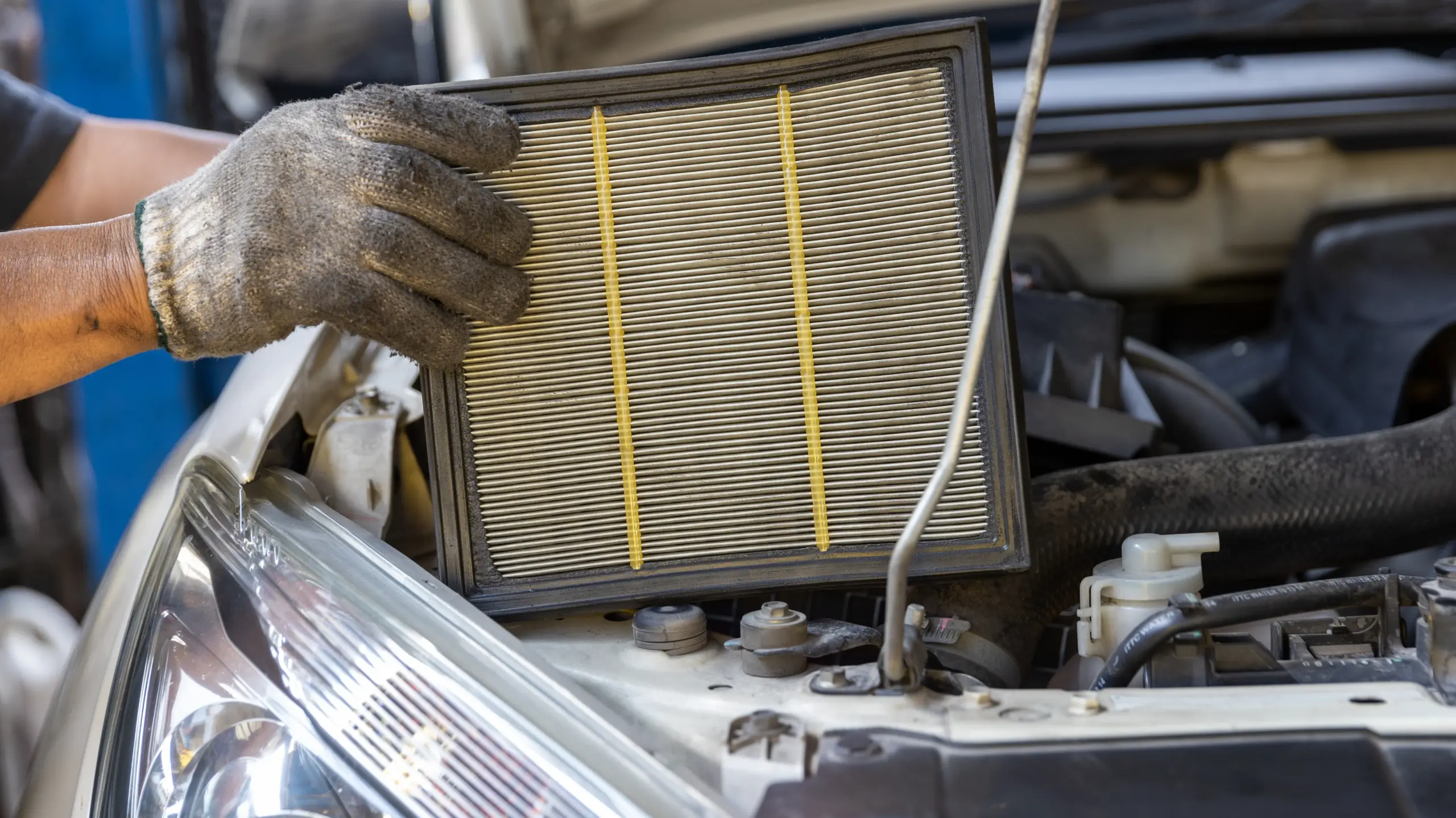 Mechanic checking and changing an air filter